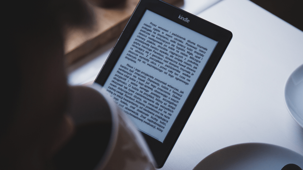 A person holding a kindle e-reader