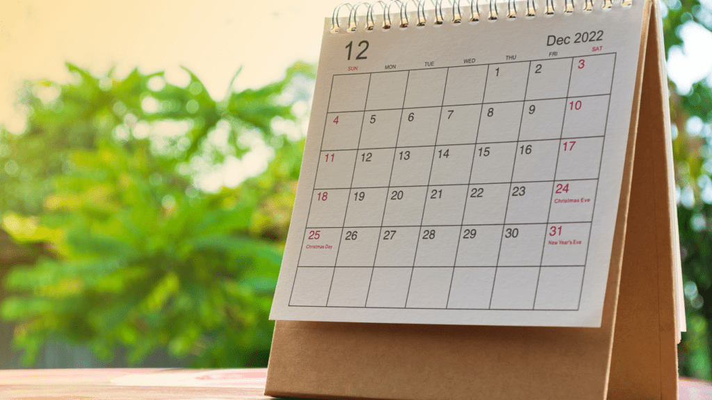 a calendar is placed on the table in front of the window