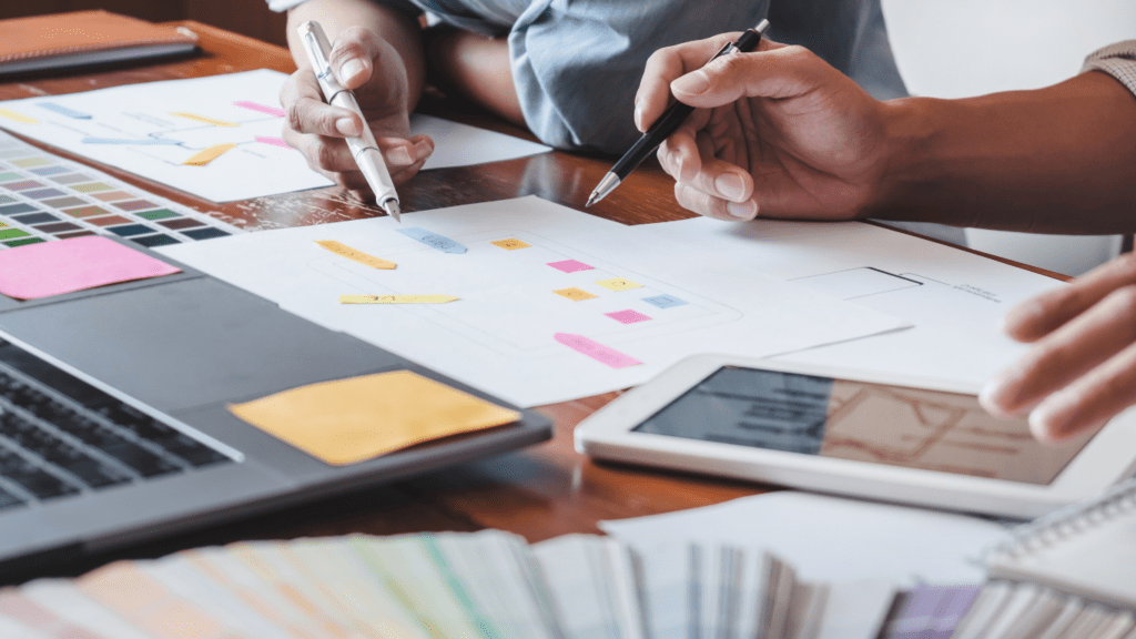 Two people working on a design project at a desk