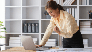 a person in a suit is working on their laptop