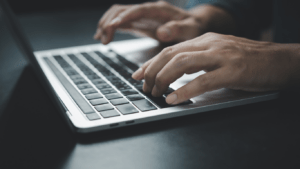 a person typing on a laptop computer