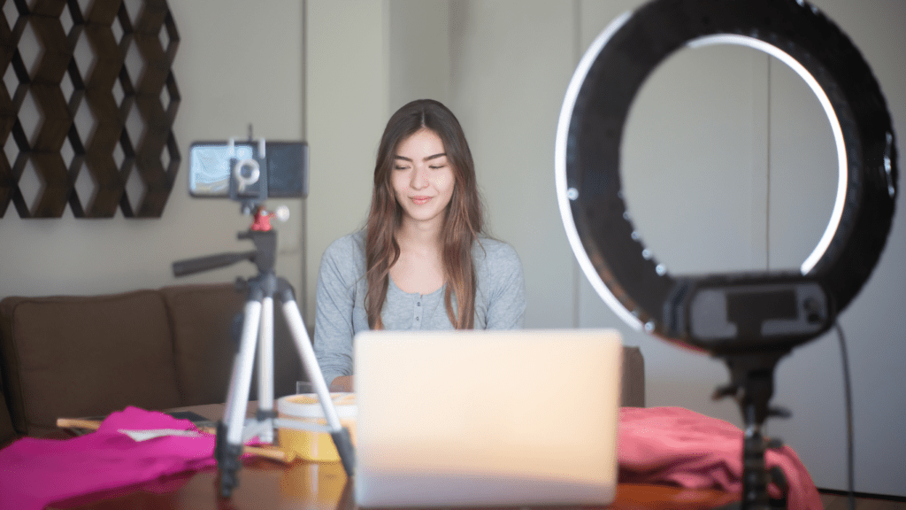 A person sitting with a ring light