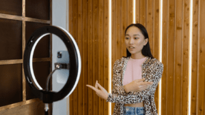 a person is standing in front of a ring light