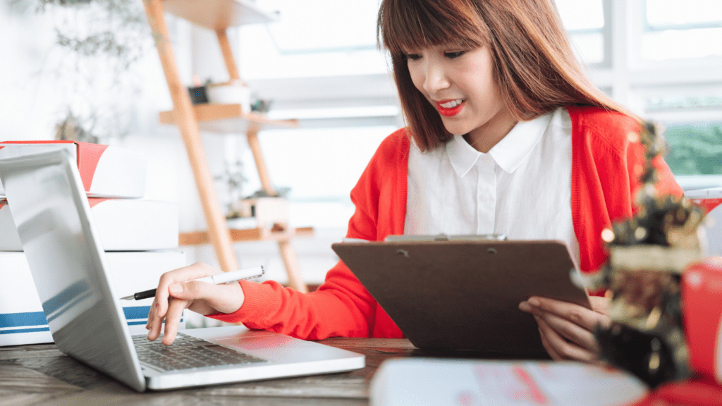 A woman working on a laptop and tablet