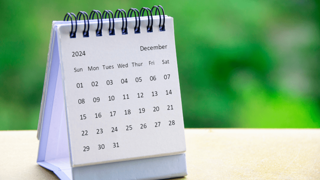 a calendar is placed on the table in front of the window