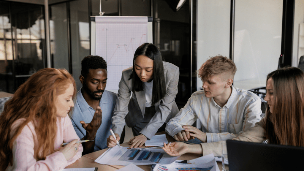 a group of business people working together in an office