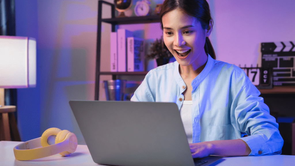 a person in a white shirt is typing on a laptop