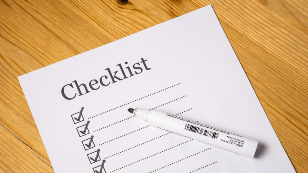 a pink pen is used to mark a checklist on a piece of paper