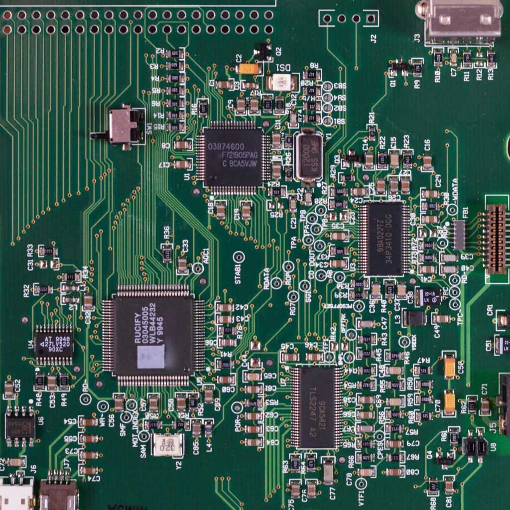 Detailed image of a green circuit board featuring various components and microprocessors.